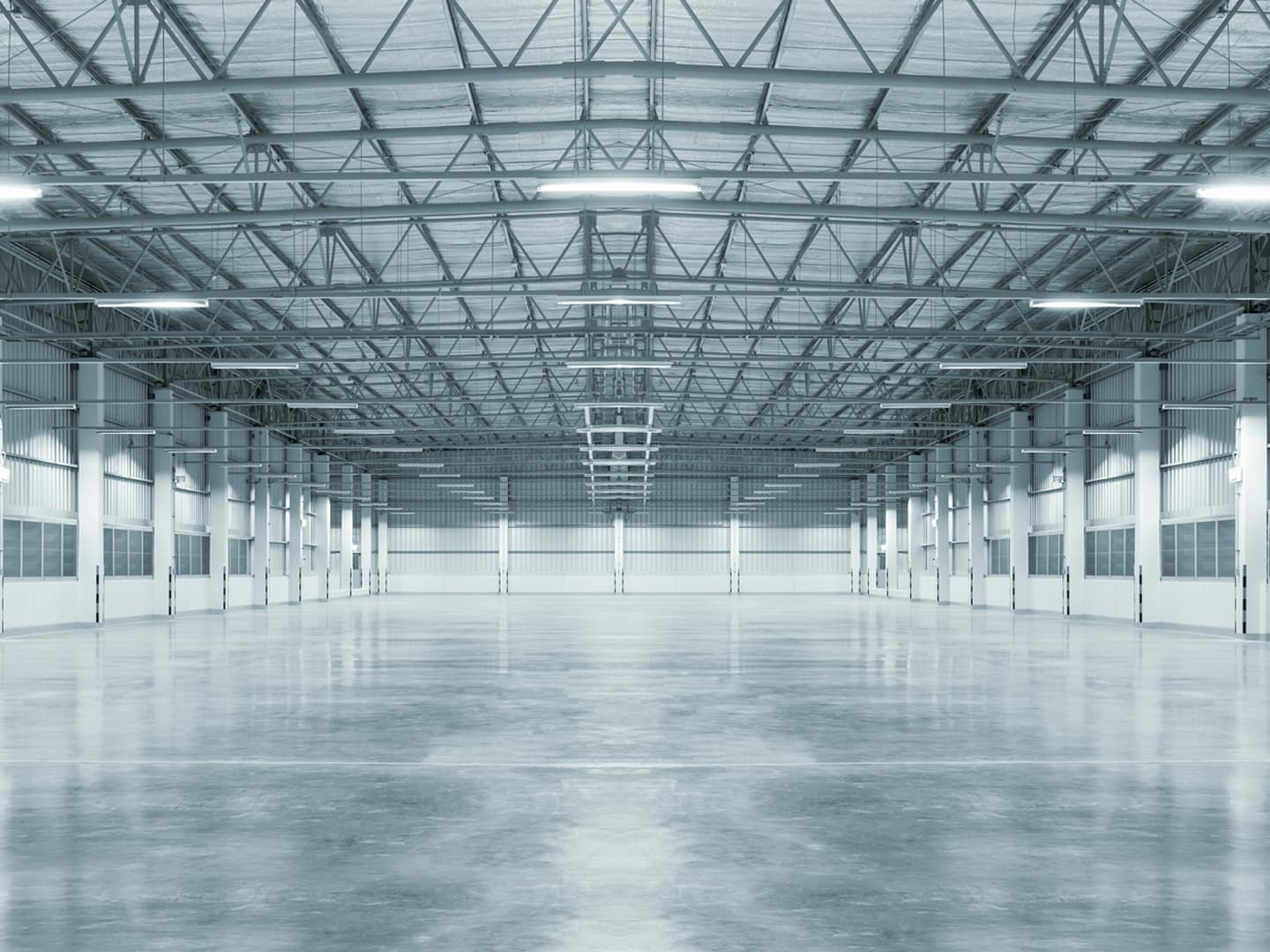 Large polished concrete warehouse flooring installed by Tenmen Construction for durability in Calgary.