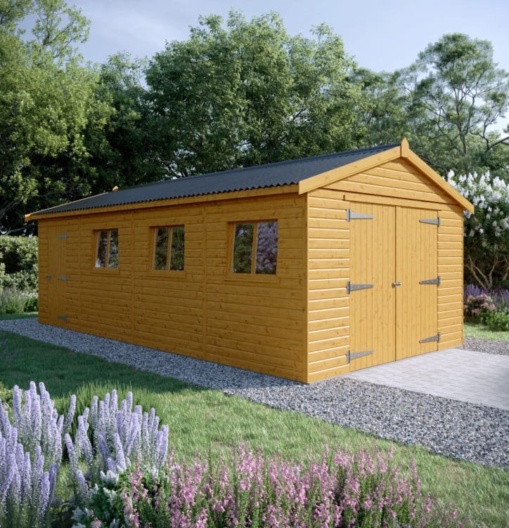 Large wooden shed built on a durable concrete slab foundation in a landscaped yard.