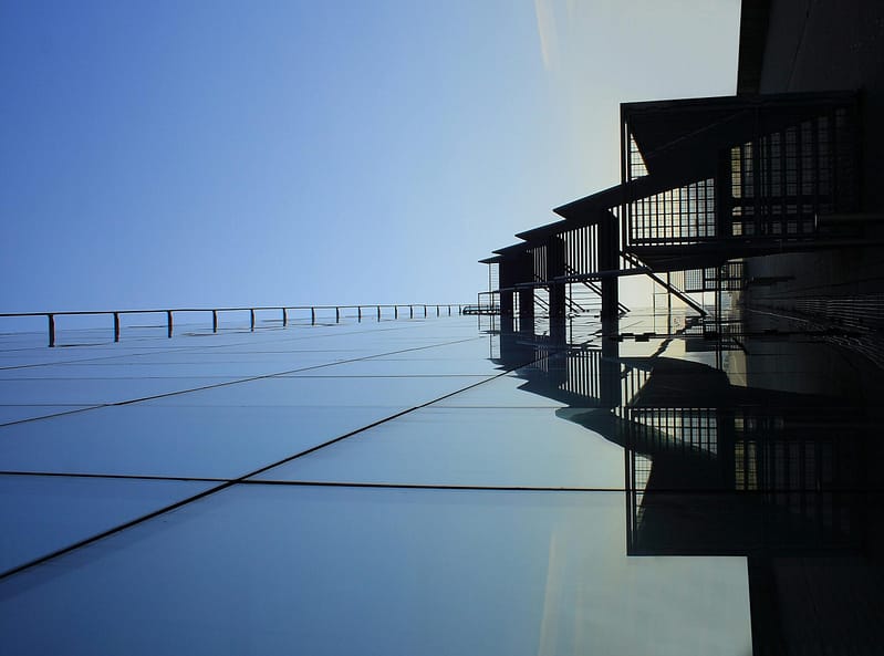 Low angle view of commercial high-rise building with reflective glass panels